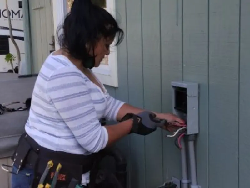 Licensed electrician wiring an exterior subpanel in Leland